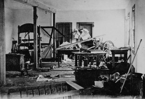 Black and white photo of a disarranged printing press