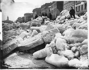 A massive pile of ice slabs with people overlooking them