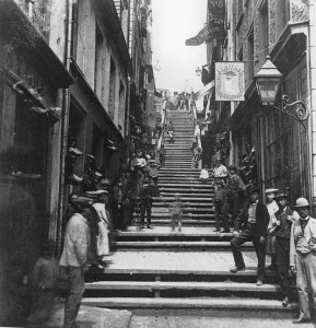 An alley staircase leads between buildings