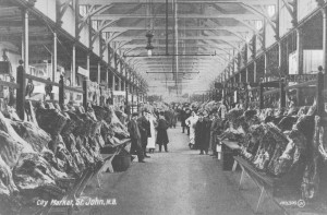 Interior photo of a slaughterhouse aisle lined with hanging meat