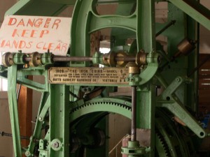 A machine labeled "The Iron Chink" with a sign reading "Danger Keep Hands Clear"