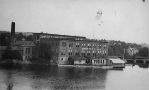 A factory on a waterfront with signage reading "Renfrew Textiles Limited"