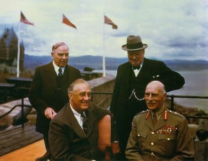 Four men together with flags in the background