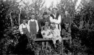 Photo of a woman and children standing in brush