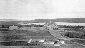 Photo of fenced buildings with teepees outside