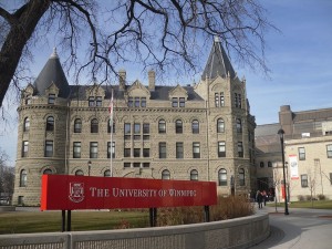 Large building facade with "University of Winnipeg" sign on the lawn