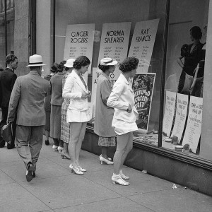 People on the sidewalk, eyeing products through store windows