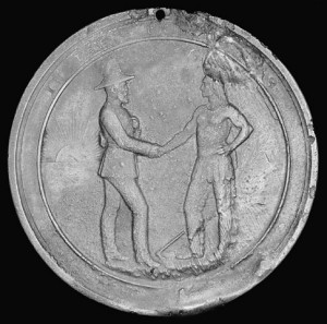 Medal depicting two men shaking hands