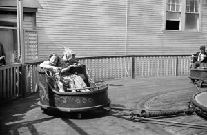 Two kids in a car of a fairground ride