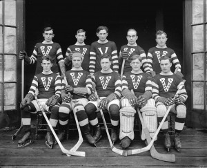 A hockey team posing for a photo in their gear