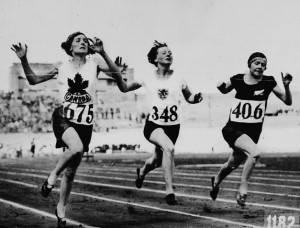 Photo of three women running on a racetrack