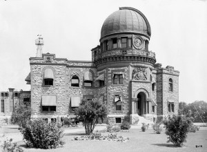 Exterior photo of a two-storey building with observatory dome