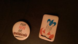 Two buttons, one labeled "mon NON est québécois", one with a blue bird emerging from a Canada egg