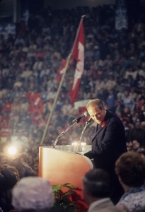Trudeau standing at a podium before a packed audience