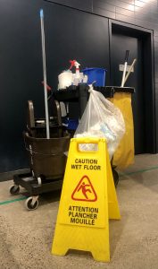 Housekeeping cart and caution wet floor sign.