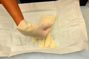 Place gloved hand under the cuff