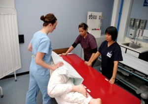 Placing a slider board (transfer board) under a patient