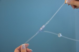 Insert secondary IV tubing into upper port on primary IV tubing