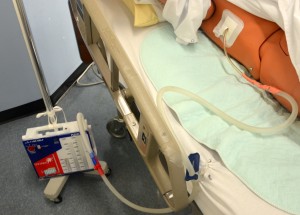Chest tube drainage system secured to IV pole