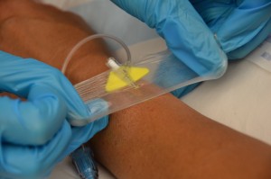 Completely remove dressing from IV site