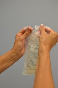 Remove IV solution from packaging