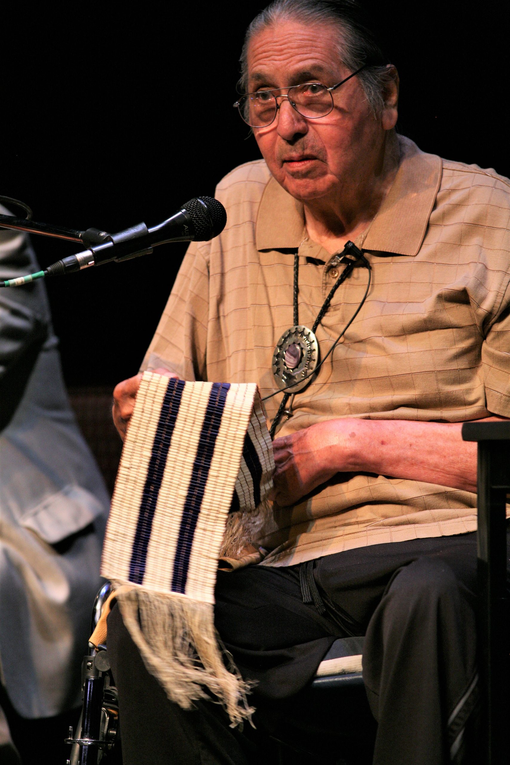 Onondaga Nation Chief Irving Powless Jr. displaying the two row wampum belt.