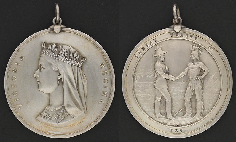 One side of the coin shows Queen Victoria in profile, wearing a crown, and says "Victoria" and "Regina". The other side says "Indian Treaty No." and "187" and shows a colonial official (left) shaking hands with a First Nation chief (right).