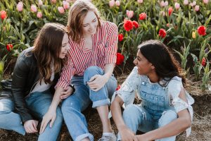 Three teenage girls sitting and talking