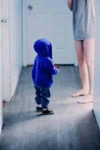 a male toddler wearing a blue hoodie, blue pants and blue shoes