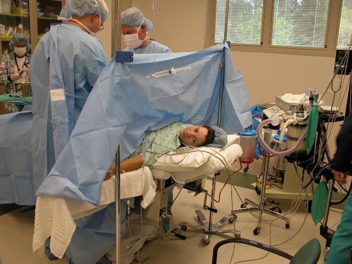 a woman in a hospital room having a c-section birth