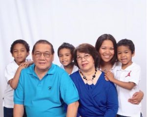 Family photo with grandparents, mother and 3 young children.