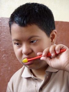 A boy brushing his teeth. 