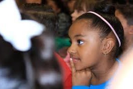 Image of a child paying attention in class.