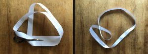 two images of the moebius strip being cut in two