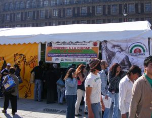 people standing in front of a tented kiosk in Mexico City