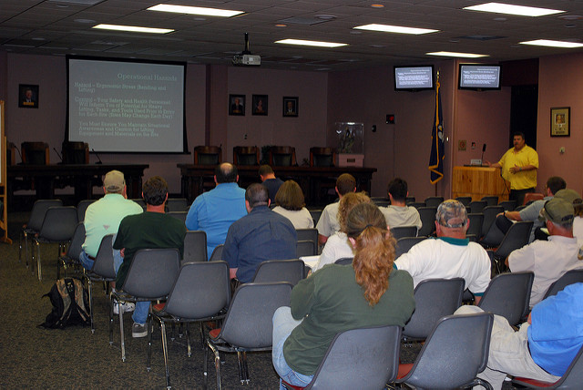 Employees attending a training classes; seated and listening to a presentation