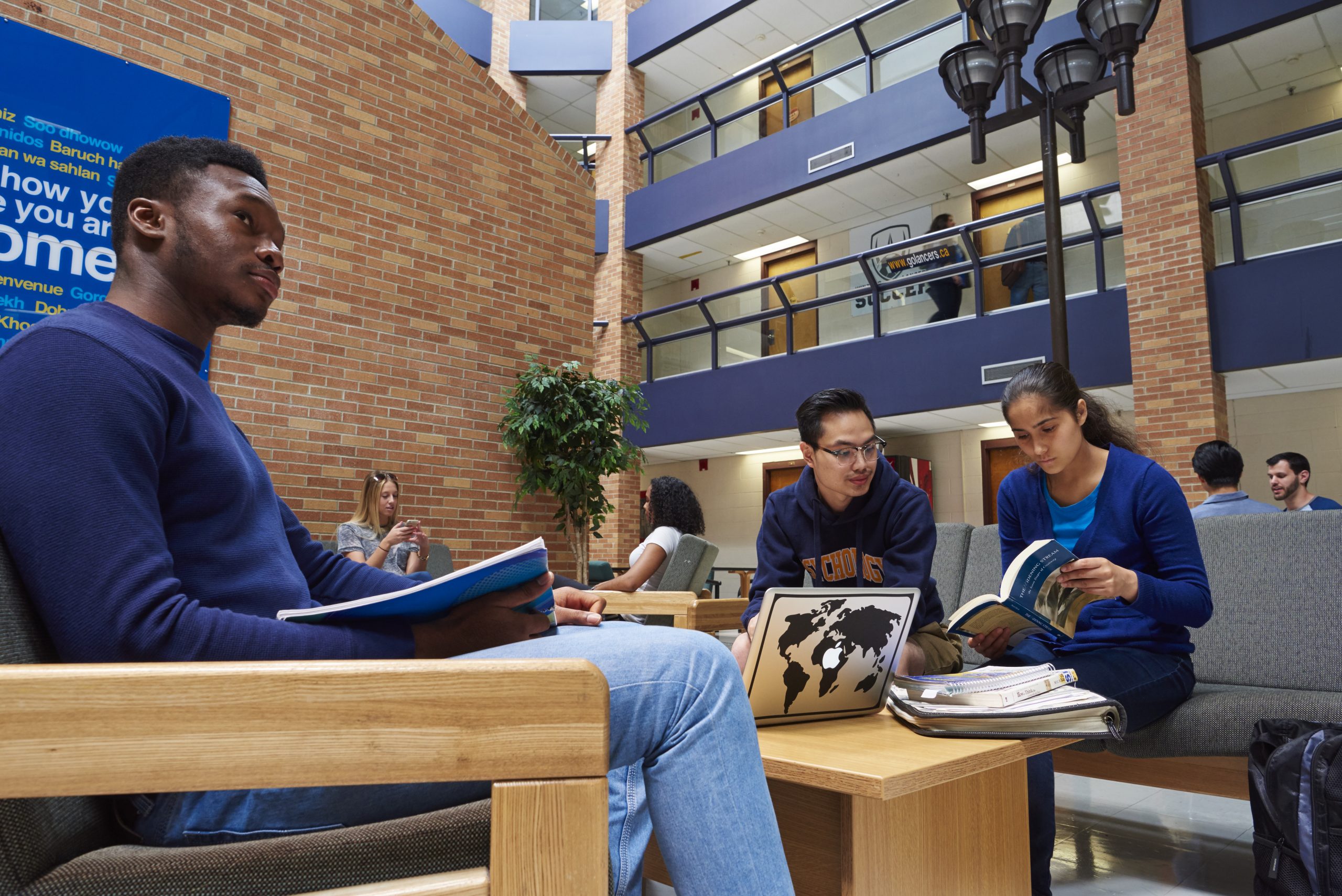 students sit together in a residence building on the University of Windsor campus