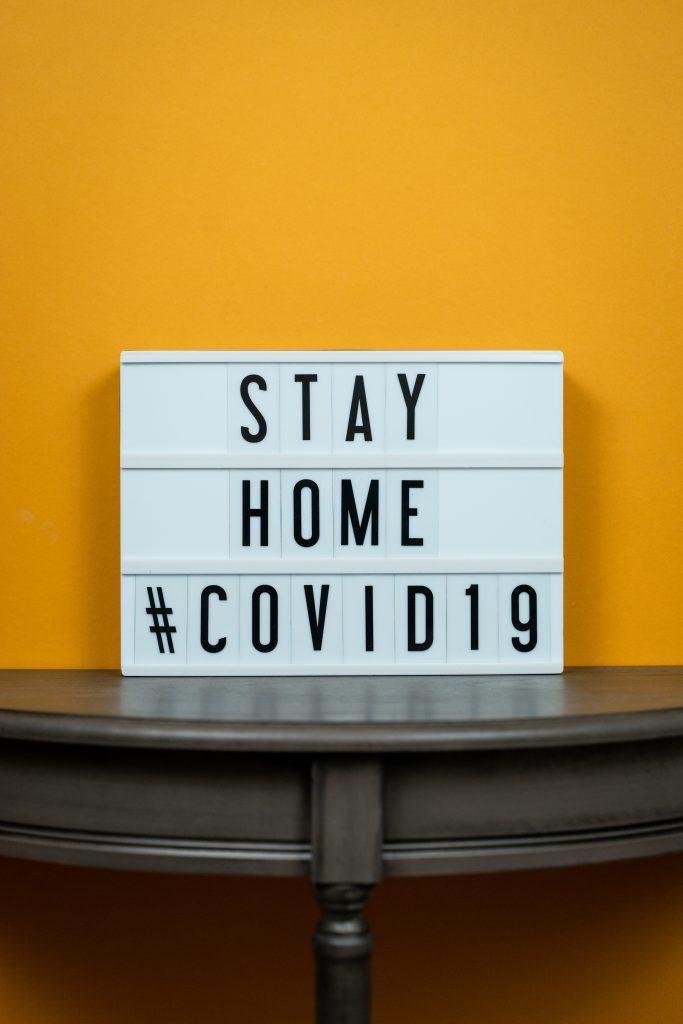 a lightbox sitting on a small table with the text 'stay home #covid19' on it