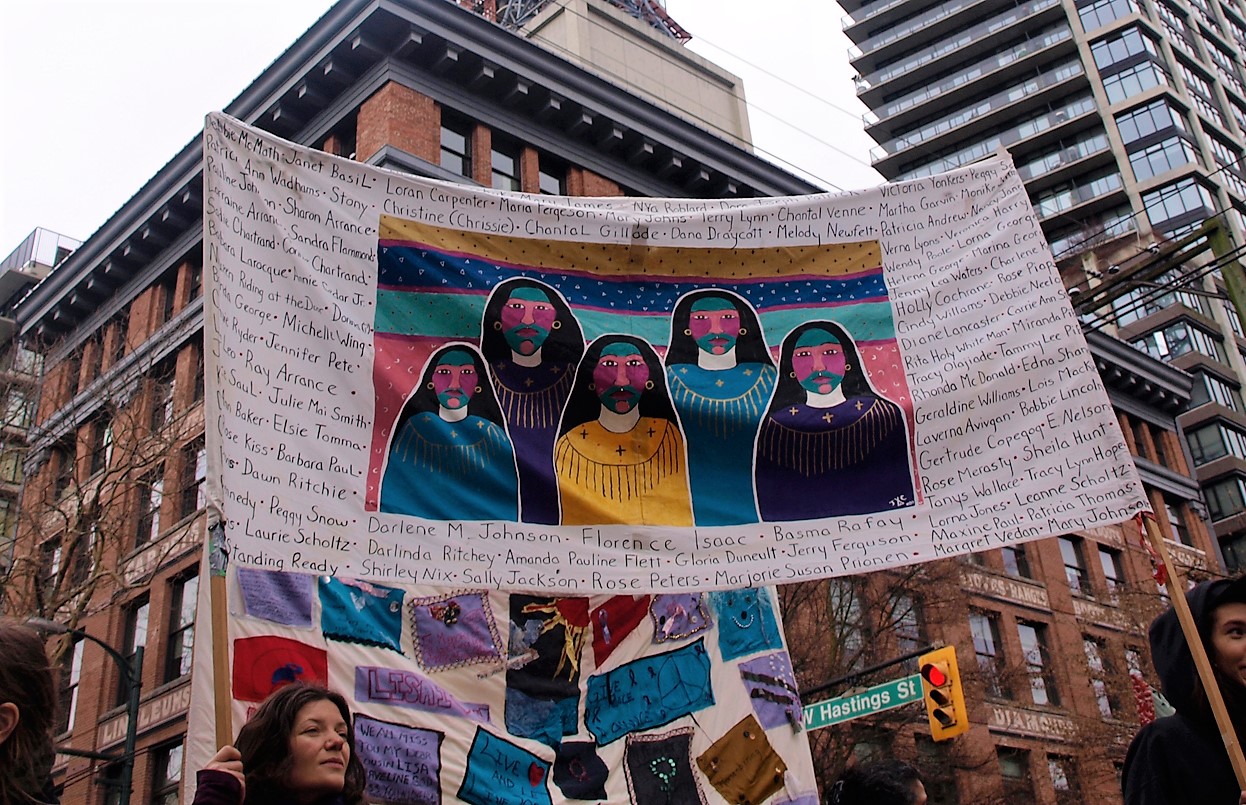 Banner with names of missing and murdered Indigenous women. 25th Annual Women’s Memorial March, Vancouver. Credits to: Jen Castro (CC BY-NC 2.0)