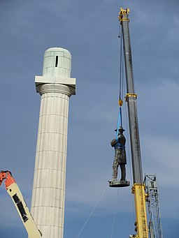 construction crew removing statue