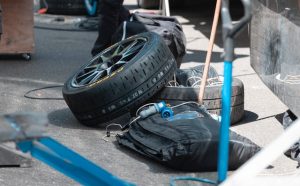Two tires at a racetrack sit ready for the pit crew to use.