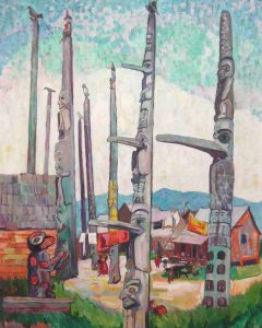 Eight gray totem poles loom high from near to far as they wind along a path between orange and gray wooden buildings to the left and right. Low bluish mountains create a horizon; a multi-hued sky above forms a backdrop to the totem poles. In the grassy foreground on the left, a detailed red and gray carving of a single animal sits on a platform.