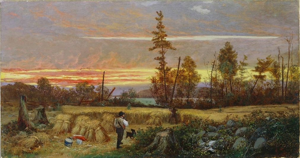 A man stands at the edge of a field as the sun breaks over the horizon. In the foreground, a few tree stumps and a pile of rocks frame him and his dog. Several sheaves of grain and two sacks—red and blue—are stacked nearby. A shadowy figure stands in the center of the field. Beyond the treeline, a lake stretches out to the horizon and distant shore. Dark gray-purple clouds are giving way to yellow, orange, and red streaks.
