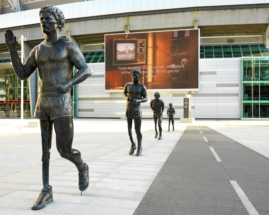 A work of public art in Vancouver, comprised of a series of four bronze statues. The figures of young Canadian athlete Terry Fox, with his distinctive prosthetic right leg, commemorate his heroic ‘Marathon of Hope’ of 1980. Each in a slightly variant pose, they grow sequentially in height from about 1.8 metres to twice life size. The memorial was designed by artist Douglas Coupland, and was executed in bronze by Stephen Harman in 2011.