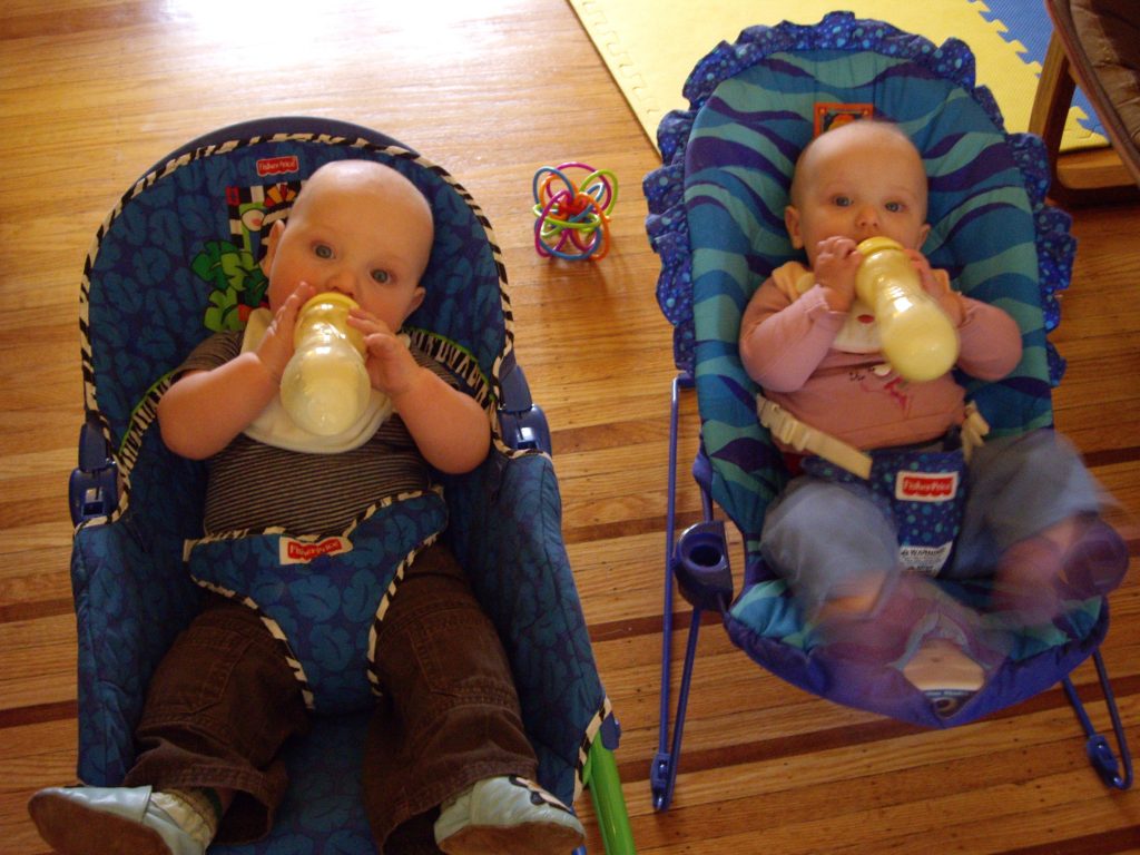 Babies drinking from milk bottles