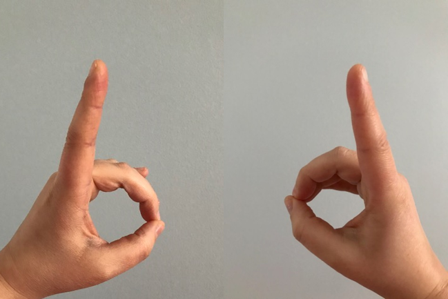An image of a left and a right hand. Each hand has the index finger raised, and the other fingers curled down touching the thumb. This gives the appearance of a letter "b" being formed with the left hand, and the letter "d" being formed on the right hand. This can be used as a reminder for dinner table etiquette: the "b" made with the left hand serves as a reminder that your bread plate is on your left. The "d" made on the right hand serves as a reminder that your drinking glass is on your right.