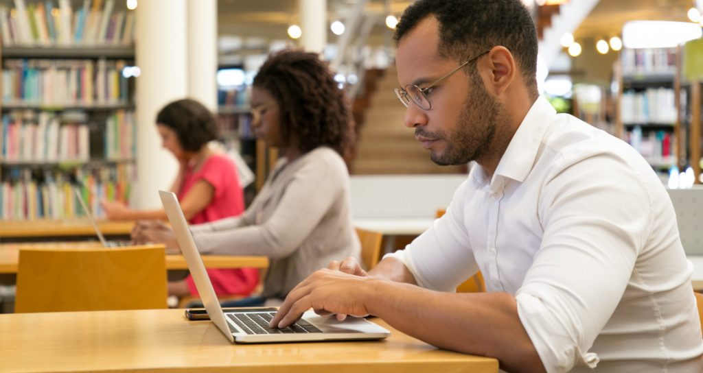 People sitting at desks and using laptops.