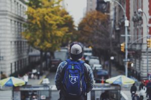 Man with backpack on street.