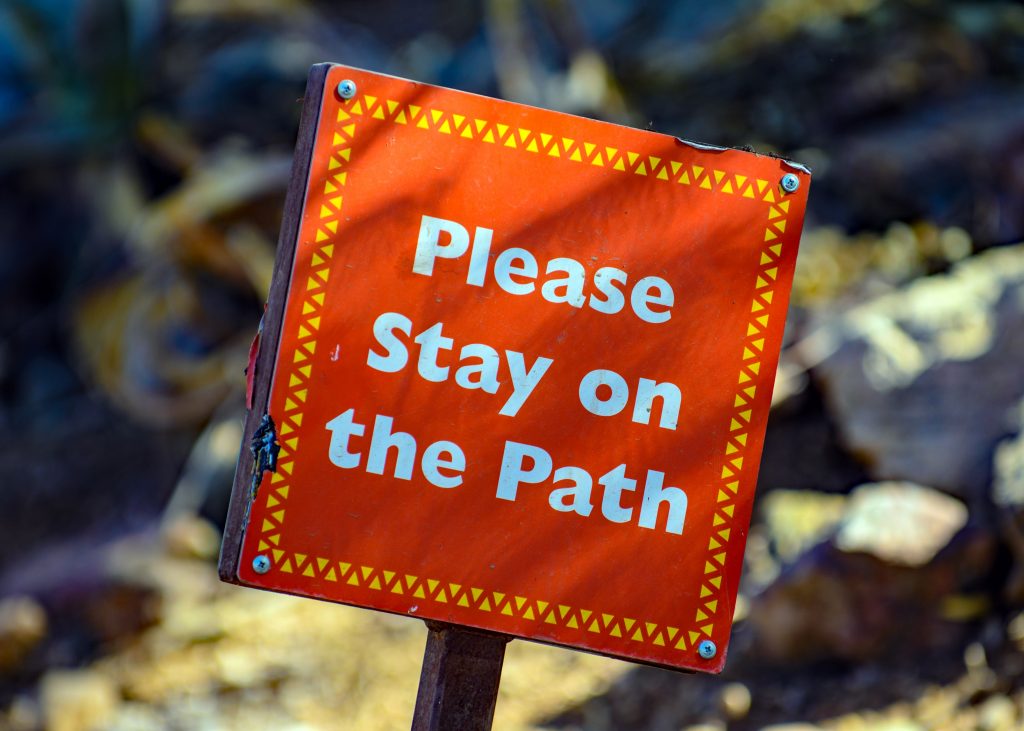 Please stay on the path sign.