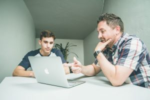 Two men meeting in a small room.